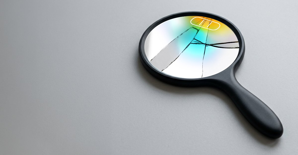 Cracked magnifying glass with bandage on gray background